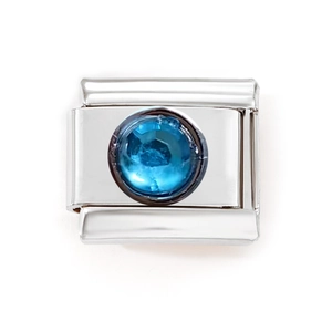 Detailed close-up of a blue gemstone charm on a modular stainless steel link bracelet