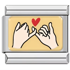 Macro shot of stainless steel Italian charm link with pink heart and pinky swear graphic