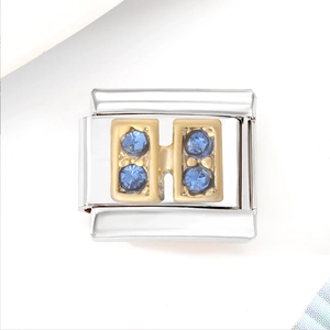 Detailed macro view of silver stainless steel charm links with four blue zircon stones