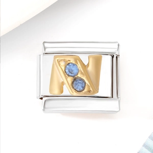 Detail of silver stainless steel charm link with gold letter N and blue zircons
