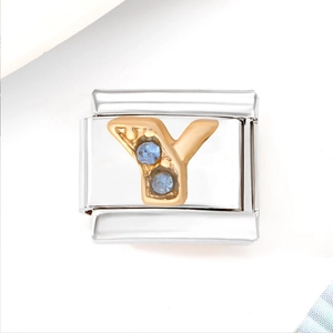 Macro view of stainless steel bracelet link with golden letter Y and blue zircons
