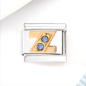 Macro detail of Italian style silver charm with golden letter Z and light blue crystals