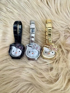 Three Hello Kitty charm watches in black, silver, and gold with rhinestone bows and metal bands
