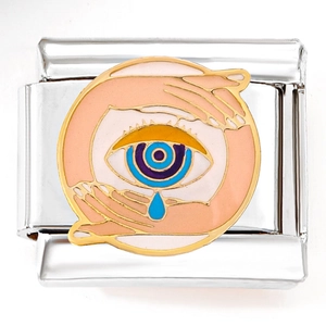 Detail of Italian charm link featuring an enamel eye with a blue teardrop and gold edges