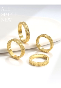 Detailed view of four S925 sterling silver gold rings with crushed ice hammered texture