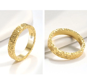 Macro detail of S925 sterling silver ring with hammered texture and engraved hallmark