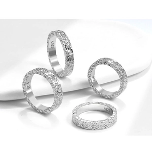 Macro detail of S925 sterling silver rings with ice-crushed texture and hallmark stamps