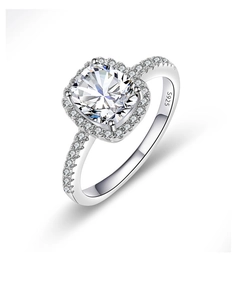 Macro shot of cushion-cut silver ring with S925 engraving and halo pavé diamond details