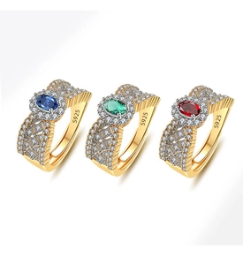 Macro shot of S925 silver cocktail rings with woven gold texture and emerald gemstones