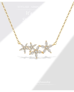 Detail of flower necklace with gold chain and marquise-cut crystal petals in high gloss