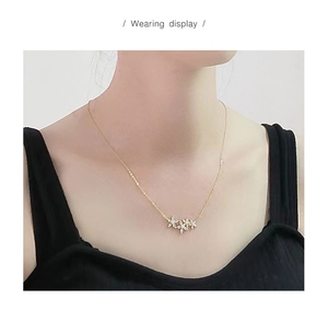 Close-up of S925 silver flower pendant with 18k gold plating and pavé set cubic zirconia