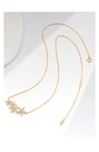 Close-up of S925 sterling silver stamp on 18k gold flower necklace with zircon