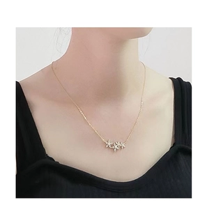 Detail of S925 sterling silver flower necklace with 18k gold plating and zircon stones