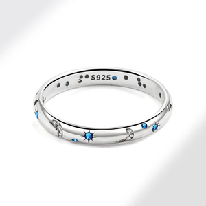 Anello in argento S925 cielo stellato con pietre blu e bianche su sfondo grigio