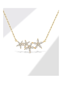 Detailed view of four marquise zircon flower pendants on a delicate 18k gold chain