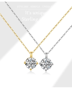 Detailed view of sterling silver necklaces featuring round-cut sparkling cubic zirconia pendants
