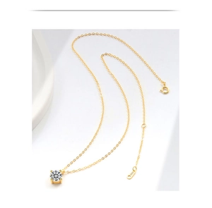 Detail showing the S925 hallmark on the gold chain of a single diamond pendant necklace