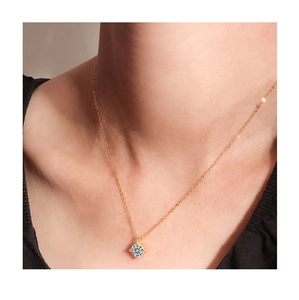 Close-up of minimalist S925 silver single diamond necklace worn on a gold chain