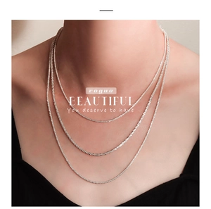 Close-up of a three-layered s925 sterling silver sparkling necklace on model neck