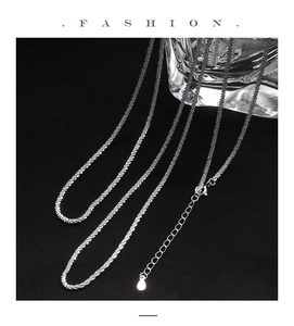 Detail of s925 sterling silver sparkling chain with lobster clasp and teardrop charm