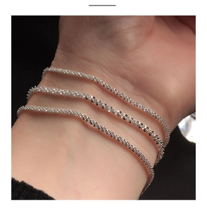 Close-up of sparkling S925 sterling silver chain with a shimmering starlight texture