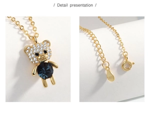 Detailed view of S925 sterling silver bear pendant with blue crystal and pave stones