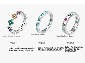 Detailed macro view of S925 silver rings with colorful clover and turquoise heart designs