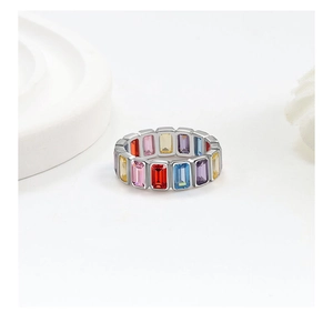 Macro shot of silver ring with colorful baguette-cut stones in a rainbow pattern