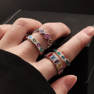 Close-up of S925 sterling silver rings with colorful clover and heart gemstones