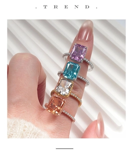 Close-up of stacked S925 sterling silver rings with colorful emerald-cut cubic zirconia