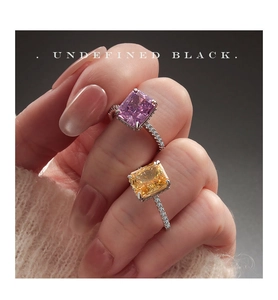 Close-up of radiant cut pink and orange zircon rings on hand with micro-pave silver bands