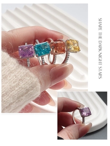 Macro detail of four S925 silver rings with colorful stones and pave diamonds
