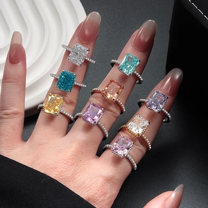 Set of nine multi-colored rectangular gemstone rings in S925 sterling silver on a hand