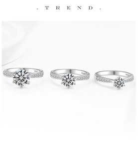 Detailed close-up of three S925 sterling silver rings with six-prong moissanite settings