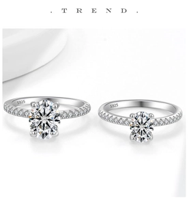 Macro shot of S925 sterling silver rings with oval-cut moissanite stones and pavé setting