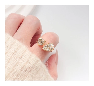 Detail of s925 silver ring featuring heart and pear cut crystals on a model's hand