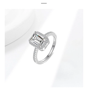 Close-up of S925 silver ring featuring emerald cut moissanite and halo stones