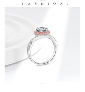 Macro view showing brilliant round diamond with pink gemstone halo on white gold ring