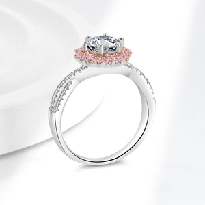 Two-tone silver and rose gold ring with a large round center stone and pink halo detail