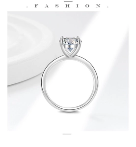 Macro side view of round cut moissanite ring with polished six-prong silver setting