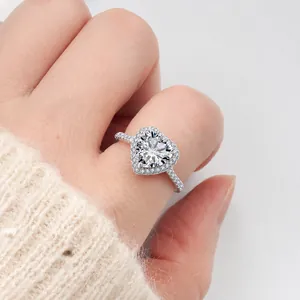 Macro shot of an elegant heart-shaped moissanite ring with halo diamonds on a S925 silver band