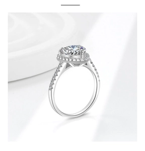 Detailed side view of Moissanite ring featuring a heart-shaped base and pavé diamond band
