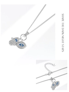 Vue détaillée des pendentifs main de Hamsa et œil bleu en argent 925 et zircons