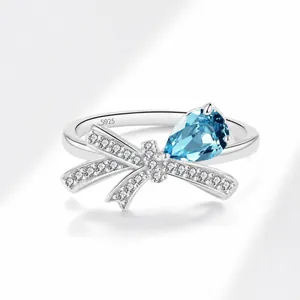 Macro shot of S925 sterling silver bow ring with blue teardrop stone and pavé zircon detail