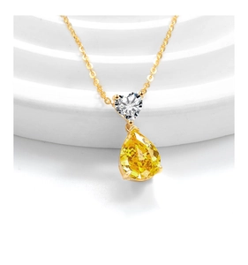 Detailed macro view of S925 silver necklace with heart-shaped and pear-cut yellow gemstones