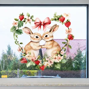 Close-up of Easter window sticker featuring kissing bunnies inside a heart-shaped floral wreath