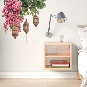 Detail of pink floral wall stickers with vintage lanterns and tassels for bedroom decor