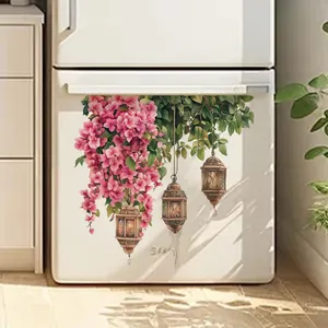 Close-up of floral wall stickers with pink blossoms and lanterns on a white fridge surface