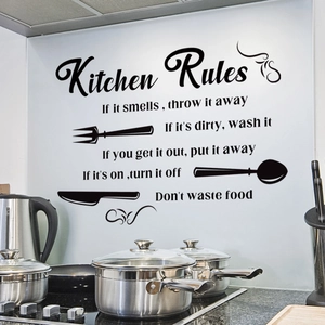 Detail of Kitchen Rules wall decal with black vinyl lettering and cutlery icons on a wall