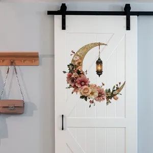 Detail of floral crescent moon wall sticker with a vintage lantern on a white barn door